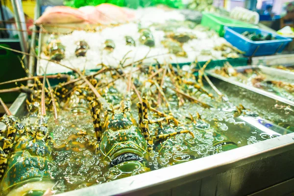 Fresh lobsters on ice for sale at restaurant.
