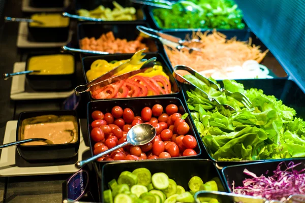 Salad bar with vegetables in the restaurant