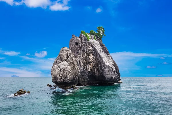 Tropical rock islands, for diving against blue sky