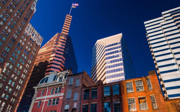 Looking up at a mix of modern and old buildings in Baltimore, Ma