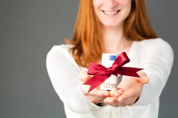 Happy woman giving money as a gift