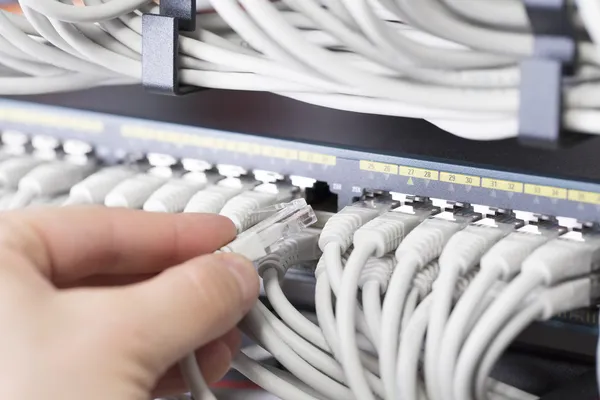 It technician plugs in network cable