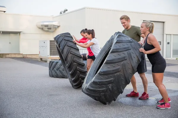 Workout team flipping tires outdoor