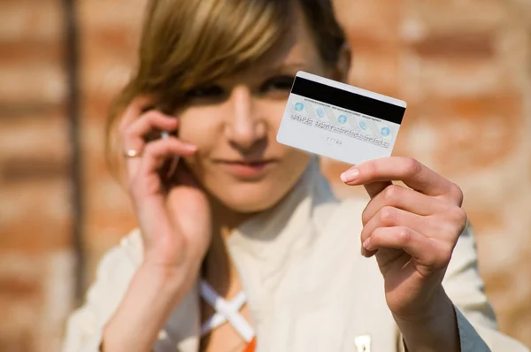 Girl with credit card and mobile phone