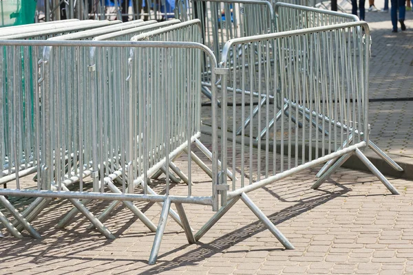 Metal barriers separating people at the concert.