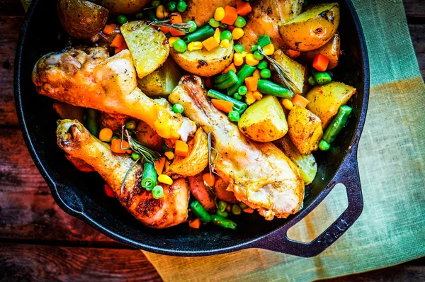 Oven baked chicken with potatoes and vegetables