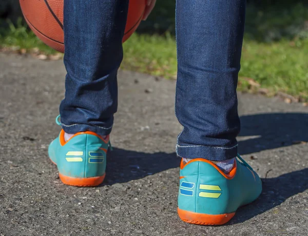 Waist-up close-up of a child playing Basketball