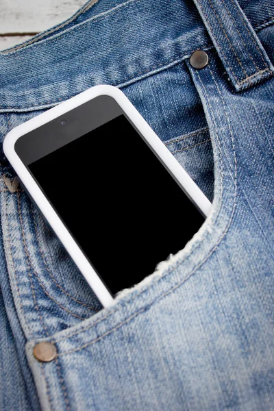 Close up of smart phone in pocket jeans