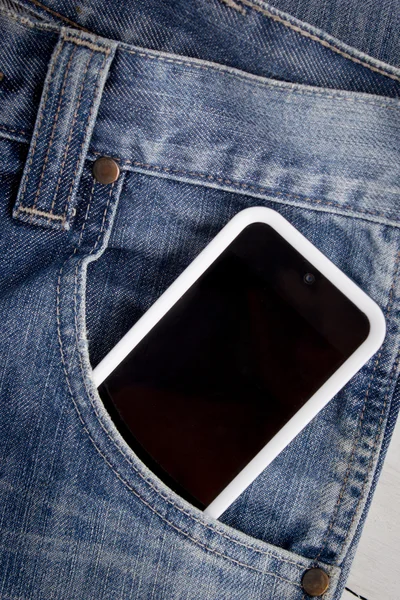 Close up of smart phone in pocket jeans