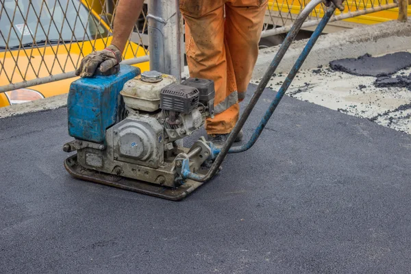 Asphalt worker with compactor plate