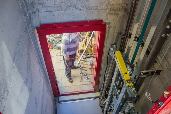 In elevator shaft, installing elevator