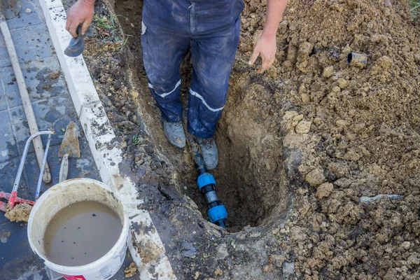 Utility worker in trench repair the broken pipe 3