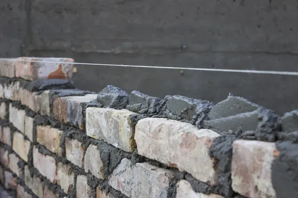 Brick laying, bricklaying spreading a bed joint