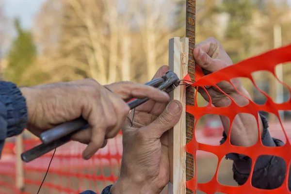 Builder worker Installing Construction Safety Fence 2