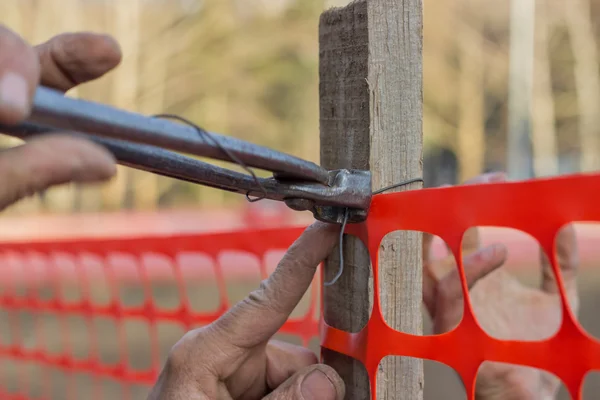 Builder worker Installing Construction Safety Fence