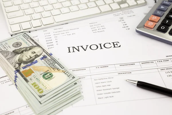 Invoice documents  and dollar money banknotes on office table