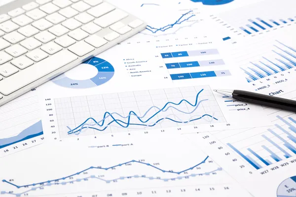 Blue graph and chart reports on office table