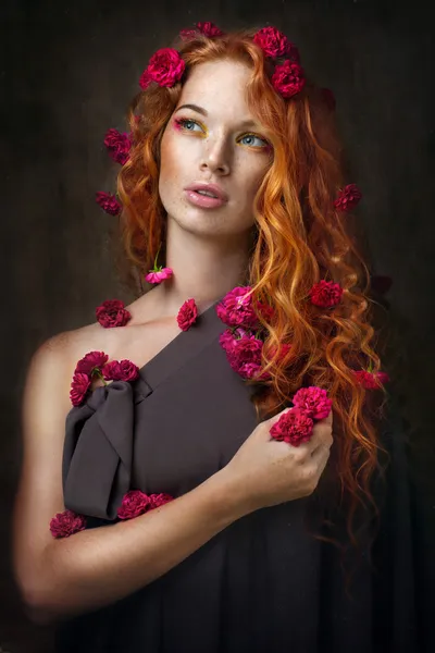 Red-haired girl in flowers