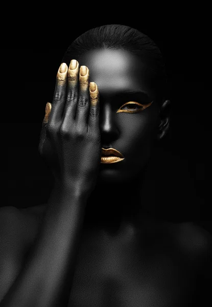 Dark-skinned woman with golden make-up.