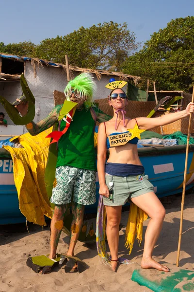 Unidentified man and woman in strange costumes at the annual festival of Freaks, Arambol beach, Goa, India, February 5, 2013.
