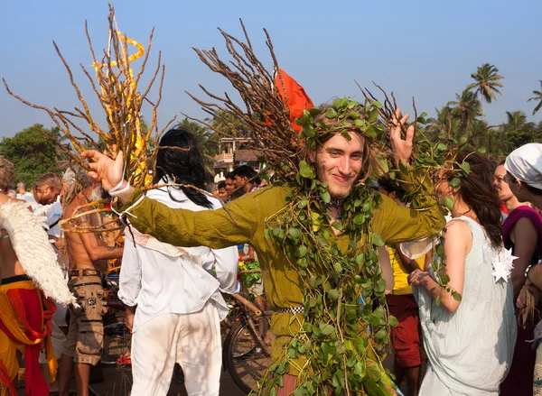 A man in a green suit made of natural materials at the annual festiva, Arambol beach, Goa, India, February 5, 2013. Participants, spectators and all the tourists have fun with a lovely mood.