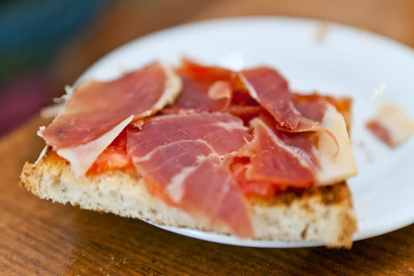 Thinly sliced ham on bread
