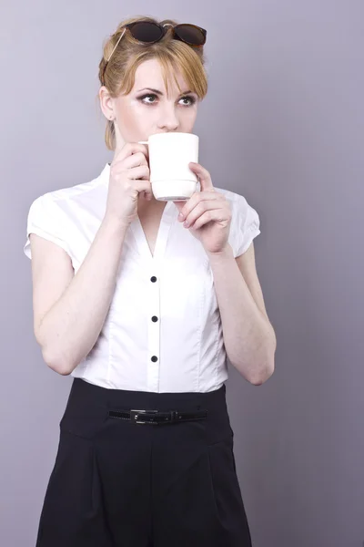 Charming young business woman drinking coffee