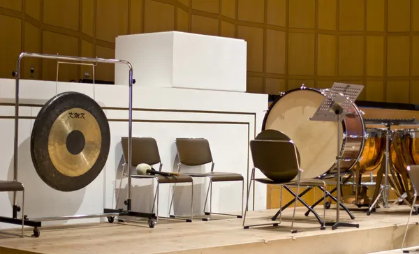Group of classical percussion instruments on a large wooden stage