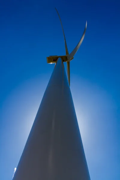 Bottom-up Perspective of a Large High Tech Industrial Wind Turbine with Halo from Sun Backlight.