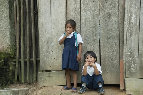 Bora Indian children wait their parents after study in school in Padre Cocha, Amazon, Peru.