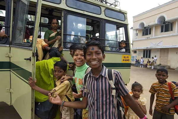 Indian children get on a school bus after visiting a church service in Vizhinjam, Kerala, India.