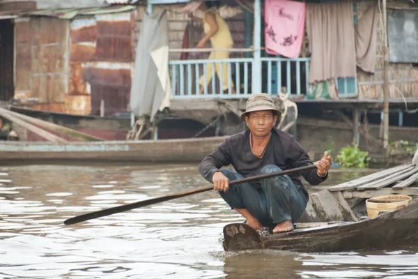 Vietnamese man paddles on a water street in Mekong Delta area, Vietnam.