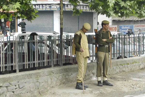 Indian policemen on a street of Srinagar, India.