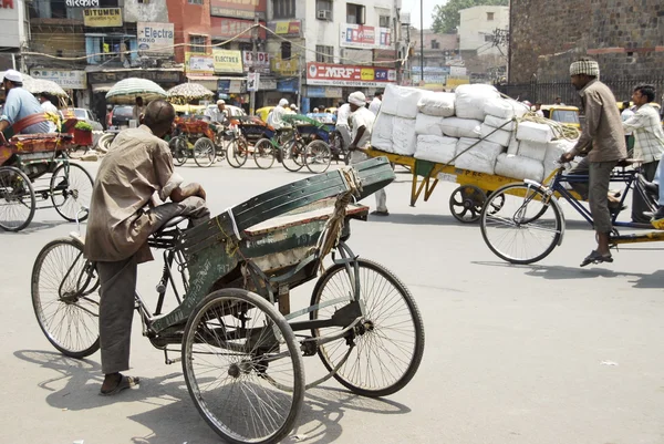 Indian rickshaw man waits his passengers on a street in New Delhi, India.