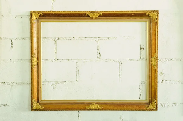 Vintage gold picture frame on white wall