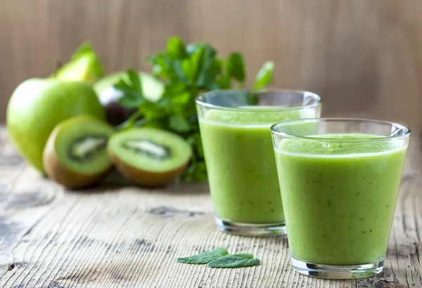 Healthy green Smoothie on wooden table