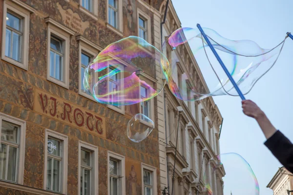 Boy makes big bubbles on Old Town Square Prague