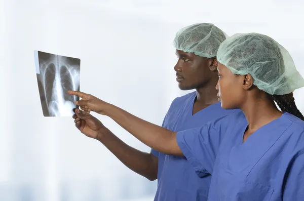 African doctors watching x-ray image of lungs
