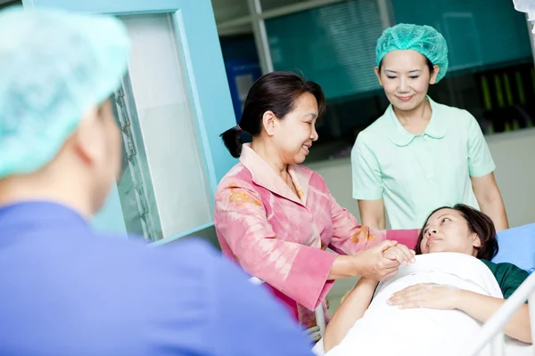 Medical workers moving patient to operating room