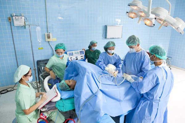 Doctor in operation room with his team