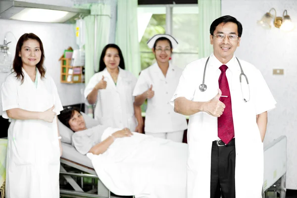 Doctor, his co-workers talking with a patient