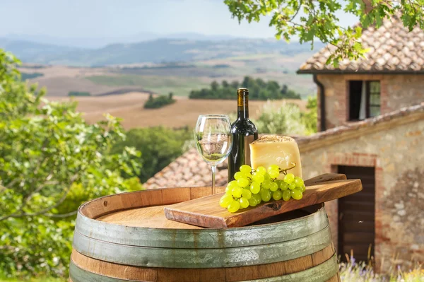 Grapes with cheese and wine in a beautiful landscape, Italy