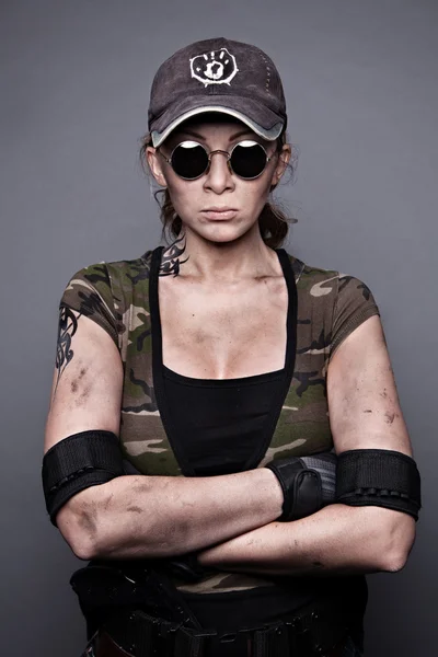 Portrait of a strong woman in dressed in a camouflage