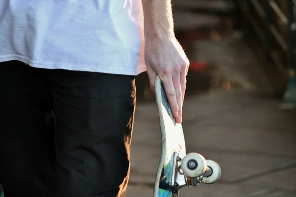 Skateboard close up in skate park with graffiti