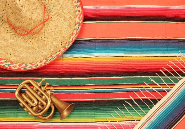 Fiesta poncho rug in bright colours with sombrero background with copy space