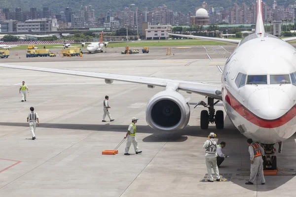 Airport ground handing operations on tarmac in Taipei SongShan A