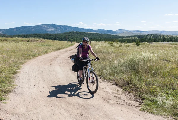 People travel by bicycle into the wilderness