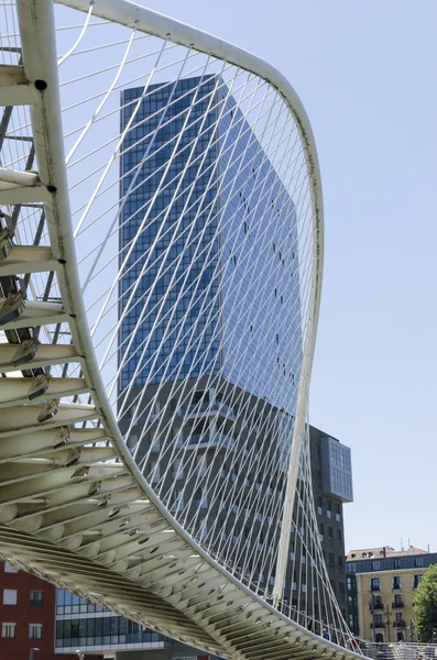 BILBAO, SPAIN - MAY 16, 2014: Zubizuri Bridge made by Santiago Calatrava in Bilbao, Spain, on May 16, 2014. It is a modern arch bridge that hangs over the river Nervin in Bilbao.