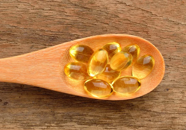 Fish oil capsules in a spoon