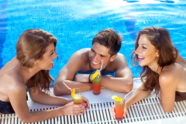 Guy flirting with two women at the swimming pool